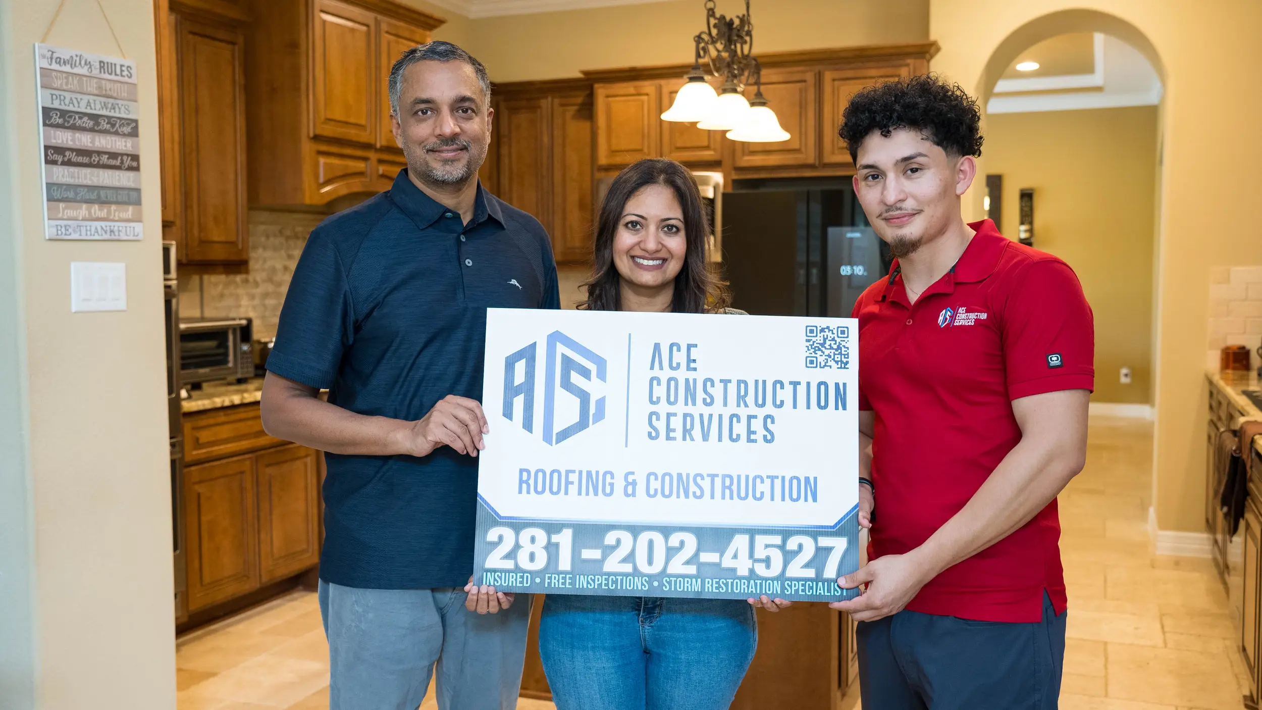 homeowners and rob (owner) holding up roofing yard sign